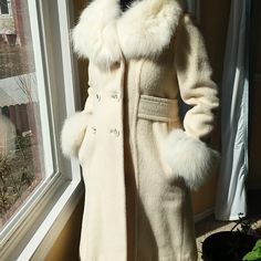 Fitted Cream White Wool Coat With Fur On The Sleeves And Collar. Belt Goes Around The Coat. Has 6 Buttons On The Front. The Coat Is From A Brand Called Charmossa. Elegant Cream Outerwear For Winter, Classic Fitted Cream Wool Coat, Fitted Winter White Wool Outerwear, Winter White Long Sleeve Formal Outerwear, Formal Winter White Long Sleeve Outerwear, Luxury Fitted Cream Outerwear, Fitted Cream Wool Outerwear, Cream Fitted Long Wool Coat, Fitted Long Cream Wool Coat