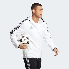 adidas Tiro 23 Men's League Windbreaker Born for the beautiful game. When the weather shows no intention of playing ball, zip up this adidas football windbreaker. Part of the Tiro 23 League range, it'll shrug off light showers and breezy conditions thanks to its woven, water-repellent shell. Its slim fit means you can pull it on over your jersey without sacrificing mobility. AEROREADY ensures you'll stay comfortable while it's on.Made with 100% recycled materials, this product represents just one of our solutions to help end plastic waste. Slim fit Full zip with lined hood 100% recycled polyester plain weave Mesh lining AEROREADY Side seam zip pockets Elastic cuffs and hem The Beautiful Game, Adidas Football, Play Ball, Nike Zoom, Product Label, Adidas Men, Water Repellent, North Face, Red And Blue