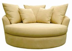 a large round chair with pillows on it's back and two sides facing each other