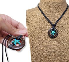 "Sea Star Necklace Pendant with Adjustable Black Cord. Pendant is Handcrafted with Coconut Shell Wood and the Sea Star is made of Howlite Turquoise Sea Turtle Symbolize: Good health and Long life Coconut Shell Wood is a symbol of life Sea Star Symbolism: The star as well as the sea stars are seen as celestial symbols. They represent infinite divine love. In addition to love, the starfish also holds characteristics such as guidance, vigilance, inspiration, brilliance and intuition Dimensions: Sea Turquoise Necklace With Starfish Charm For Jewelry Making, Adjustable Turquoise Jewelry With Star Charm, Star-shaped Ocean-inspired Necklaces For Beach, Handmade Starfish Shell Necklace, Ocean-inspired Style, Beach-style Oval Wooden Beaded Necklaces, White Shell Necklace With Starfish Charm, Ocean-inspired, Adjustable Shell-shaped Necklace For Beach, Surfer Necklace, Turtle Design