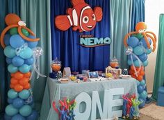 an under the sea themed birthday party with balloons, decorations and table cloths on display