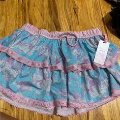 Brand New Never Worn Flowy Blue Feminine Skirt, Feminine Blue Tiered Skirt, Pink Cotton Mini Skirt For Vacation, Cute Blue Tiered Skirt Bottoms, Pink Beach Skirt With Elastic Waistband, Cute Tiered Skirt For Vacation, Cute Beach Skirt With Ruffles, Cute Ruffled Beach Skirt, Cute Blue Tiered Skirt