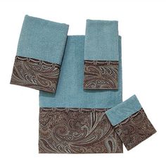 three pieces of blue and brown towels with paisley designs on them, one folded up