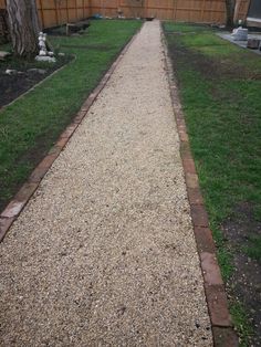 a gravel path in the middle of a yard