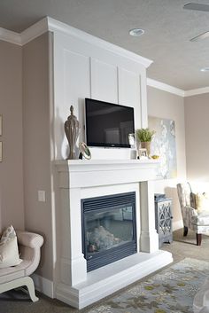 a living room filled with furniture and a flat screen tv on top of a fireplace