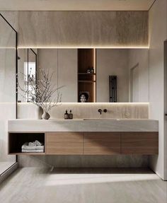 a bathroom with a large mirror above the sink and cabinets on the wall next to it