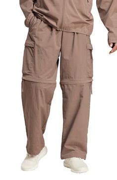 Lightweight and relaxed, these pants made of recycled nylon feature plenty of roomy pockets plus zip-off legs for easy conversion to cargo shorts. 27 1/2" inseam; 20" leg opening; 12 1/2" front rise; 15 1/2" back rise (size Medium) Elastic/drawcord-toggle waist Side-seam pockets; cargo zip envelope-patch pockets Zip-off legs allow an easy transition from pants to shorts as temps change Drawcord-toggle cuffs 100% recycled nylon Machine wash, tumble dry Imported Versatile Parachute Pants With Cargo Pockets For Outdoor, Utility Cargo Pants With Pockets For Camping, Relaxed Fit Parachute Pants With Pockets For Outdoor Activities, Relaxed Fit Parachute Pants With Pockets For Outdoor, Relaxed Fit Parachute Pants With Functional Pockets For Outdoor, Utility Bottoms With Functional Pockets For Camping, Baggy Nylon Cargo Pants For Outdoor Activities, Casual Cargo Pants For Camping, Versatile Cargo Pants For Spring Outdoor Activities