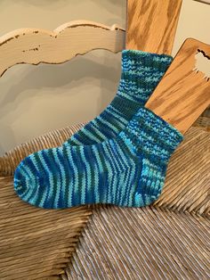 These socks were hand knit by me in a smoke free/pet free home.  The hand dyed yarn is 100% Superwash Merino wool and is soft, warm and cozy.  They are knit in stockinette stitch with a nice deep ribbing at the ankle.  The colors are different shades of blues and greens.  These socks are great for lounging around the house on those cold winter days and can also be worn with boots and clogs for extra warmth.  A great gift for that special person or as a treat for yourself. Size:  W/Medium  Care instructions:  machine wash cool/lay flat to dry or hand wash  Thank you for visiting 🧶 Casual Knitted Socks, One Size, Casual Knitted Socks One Size, Blue Casual Knitted Socks, Casual Handmade Green Socks, Casual Comfortable Hand Knitted Socks, Hand Knitted Yarn Socks Casual Style, Comfortable Blue Knitted Socks, Comfortable Handmade Green Socks, Casual Green Knitted Socks