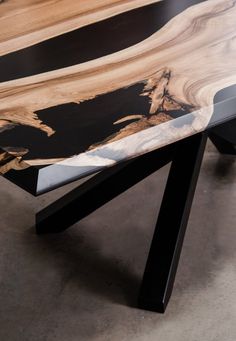 a wooden table with black and white lines on it's edge, sitting in a room