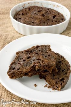 two white plates topped with brownies on top of a table