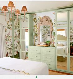 the bedroom is decorated in pastel green and has floral wallpaper on the walls