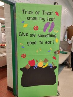 a green door with an advertisement on it that says trick or treat smell my feet give me something good to eat