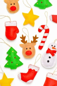 handmade christmas ornaments are arranged on a white surface with red, green and yellow stocking