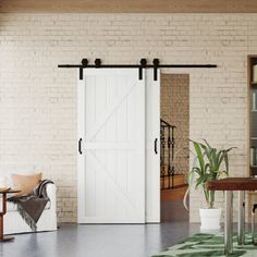 a living room filled with furniture and a sliding barn door in the middle of it