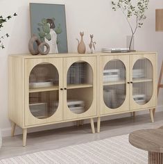 a living room scene with focus on the sideboard and shelves that have glass doors