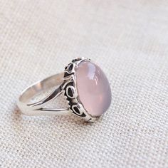 Gemstone - rose quartzGemstone Size - 10x14  oval Metal - Sterling SilverNatural rose quartz sterling silver ringTo change the ring size i request the buyer to pull the band lock in the opposite direction. The ring can be customized on request and gemstone can be switched to any gemstone you want. Feel free to contact me for any queries regarding jewelryfor bulk order please contact me through messages. The ring will be a gift wrapped in a premium handmade jewelry box. Delicate Oval Sterling Silver Rings, Pink Moonstone Sterling Silver Ring For Anniversary, Rose Quartz Crystal Ring For Promise, Promise Ring With Rose Quartz And Gemstone Detail, Dainty Cabochon Rings As Gifts, Delicate Oval Rings For Gift, Delicate Oval Rings For Gifts, Oval Cabochon Crystal Ring With Gemstone For Promise, Oval Cabochon Crystal Ring As Gift