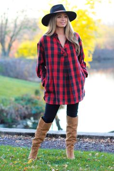 Bold plaid tunic with soft front shirring. Side pockets and curved hem. Pair with jeans or leggings and some tall boots for a true fall/winter look. -Color: Red/Black -Collar/V-neck -Loose fit -Content: 100% Cotton -Imported -Model is 5'5" 36-30-40 and wearing a size Small Country Christmas Outfits, Christmas Outfit Jeans, Christmas Plaid Outfit, Buffalo Plaid Outfit, Red Boots Outfit, Preppy Winter Outfits, Winter Boots Outfits, Trends 2025, Boots Outfit Ankle