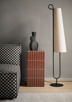 a black and white checkered chair next to a lamp