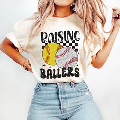 a woman in jeans and a t - shirt that says raising ballers on it