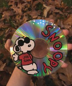 someone holding up a cd with the word snoop on it