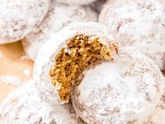 a pile of powdered sugar covered donuts sitting on top of each other