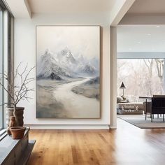 a large painting hanging on the wall in a living room