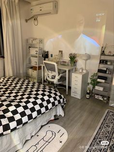 a bed room with a checkered bedspread and desk