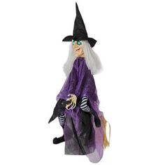 a doll dressed as a witch on a white background