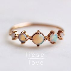 The incredible hints of blue, pink, green and purple in this ring make it so gorgeous, it feels like magic.  Our "Talisman" ring is set in 14K gold and features 5 Australian prong set opals. - Handcrafted out of solid 10K or 14K gold - Choose between rose, yellow and white gold - Round band measures 1mm - Opals measure 2mm, 3mm and 4mm (5 stones total) - Set with natural Australian Opals Processing times -  Current processing time is 1 - 3 weeks.  Each Item is handmade to order with love and car 14k Gold Opal Ring Gift, Spiritual 14k Gold Opal Ring Gift, Bohemian 14k Gold Round Rings, Celestial Multi-stone Rings For Gift, Spiritual Opal Ring Jewelry, Spiritual Opal Rings, 14k Gold Celestial Opal Ring, Celestial 14k Gold Opal Ring, Heirloom Opal Jewelry In Round Shape