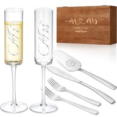 wine glasses and utensils in front of a wooden box