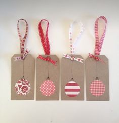 four tags with christmas ornaments hanging from them