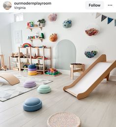 a child's playroom with various toys on the floor and in front of it