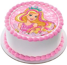 a birthday cake with a barbie doll on the top and pink icing around it