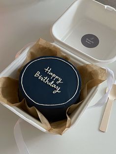 a birthday cake in a box with a happy birthday message on the front and side