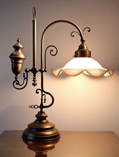 a lamp that is sitting on top of a table in front of a wall mounted light