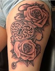 a woman's thigh with two roses on it