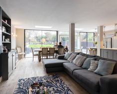 a living room filled with furniture and lots of windows