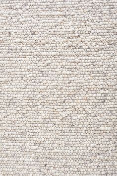 a white rug with small circles on it