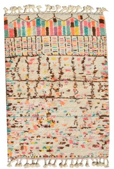 an old rug with multicolored stripes and fringes