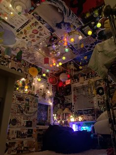 a room filled with lots of clutter and pictures hanging from the ceiling above it