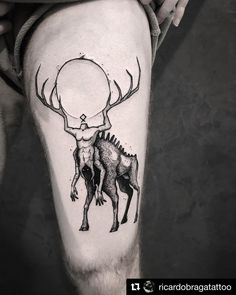 a man's leg with a deer and an antelope tattoo on it