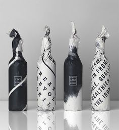 three bottles with different designs on them sitting next to each other