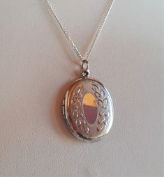 Vintage Victorian revival signed sterling silver 925 oval locket pendant necklace with beautiful floral hand engraving - can open to keep 2 photos. pendant: 1-1/8 x 7/8 x 1/8 inches. Weight: 7.2 gr. Chain : 18 inches. Good vintage condition with very fine surface scratches mostly on the back side and mostly visible under a loop - sold as is. Signed R and marked 925 in the interior of the locket and marked 925 on the chain.   IMPORTANT TO READ: To make this a smooth and pleasant transaction experience for everyone, all buyers need to read and understand the description, the terms of sale , the payment and the shipping indicated in this listing. TERMS OF SALE A. SHIPPING WORLDWIDE This listing includes payable tracked services with the fees indicated below.  B. CARRIERS We don't ship with Fe Oval Silver Necklace With Large Pendant, Vintage Silver Oval Pendant Locket Necklace, Ornate Hallmarked Oval Pendant Necklace, Ornate Antique Silver Oval Necklace, Wedding Sterling Silver Hallmarked Locket Necklace, Oval Sterling Silver Locket Necklace, Antique Sterling Silver Etched Locket Necklace, Antique Etched Sterling Silver Locket Necklace, Silver Victorian Locket Necklace With Oval Pendant