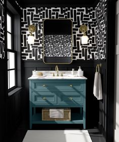 a bathroom with black and white wallpaper, blue vanity and gold accents on the mirror