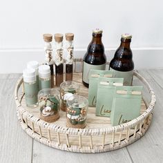 a wicker tray with bottles and paper bags on the bottom that says love in gold lettering