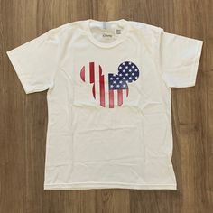 New With Tag. Disney Mickey & Friends Mickey American Flag Fill T-Shirt Size M White Themed Mickey Mouse T-shirt, White Mickey Mouse Crew Neck T-shirt, Mickey Mouse Themed Short Sleeve T-shirt, Themed Mickey Mouse Short Sleeve T-shirt, White Mickey Mouse Top For Fans, White Themed Shirt For Disney Fan Events, Themed White Shirt For Disney Fan Events, White Disney Crew Neck T-shirt, White Disney Shirt For Summer