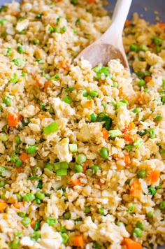 rice and vegetables are mixed together in a pan