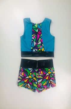 This two piece set includes a sleeveless top and a high-waisted booty short. The top is lined in the front. This set is available in sizes 4-14. Please allow 2-4 weeks for construction and shipping times as all orders are made to order. Fitted Sets With Built-in Shorts, Fitted Sets With Built-in Shorts For Summer, Fitted Multicolor Party Shorts, Fitted Sleeveless Tops For Cheerleading, Fitted Multicolor Two-piece Set, Fitted Party Sets Short Length, Summer Fitted Sets With Built-in Shorts, Fitted Multicolor Two-piece Set For Summer, Fitted Multicolor Tops Matching Set