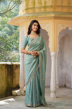 Gorgeous sea green tussar georgette saree is a perfect choice for weddings and festive occasions!. It has an embroidered border and comes with a beautiful embroidered blouse. Disclaimer: The actual product may vary slightly from the image. These are custom orders, hence expect slight variation in color, placement of the motif or buta. ESTIMATED DELIVERYBecause this is a custom order, it would take about 4 weeks from the date of purchase. RETURN POLICYThis product is a custom order and cannot be returned or exchanged. Green Slub Silk Traditional Wear With Embroidered Border, Sea Green Blouse Design, Dola Silk Sharara With Embroidered Border For Reception, Reception Dola Silk Sharara With Embroidered Border, Reception Sharara With Embroidered Border, Pista Green Embroidered Blouse Piece For Festivals, Festival Blouse Piece In Pista Green With Embroidered Border, Green Sharara With Embroidered Border For Wedding, Green Embroidered Sharara For Wedding