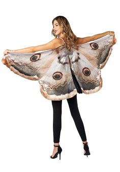 a woman wearing a butterfly costume with her hands on her hips and the wings open